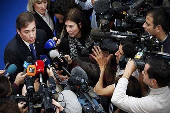 Portugal lowered to junk status as big strike hits