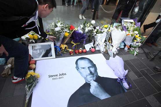 Mourners shower rose petals outside Jobs' home