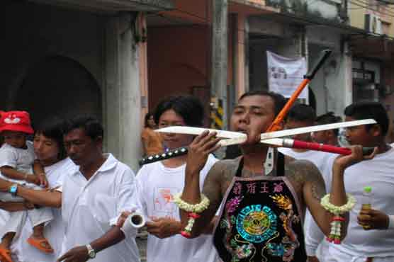 Thai people pierce faces for body purification