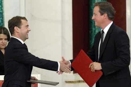 Cameron meets Medvedev, Putin in rare visit