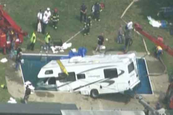 Motorhome plunges into swimming pool