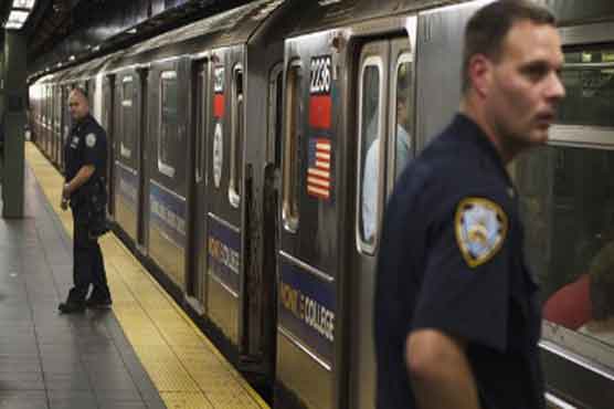 Woman held for pushing man in front of train 