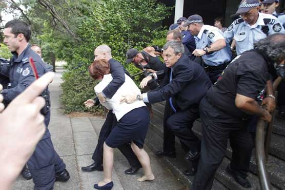 Australian PM stumbles before angry protesters