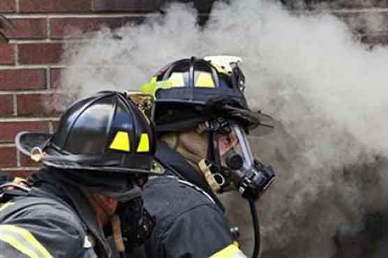 On a New York island, firefighters set homes ablaze