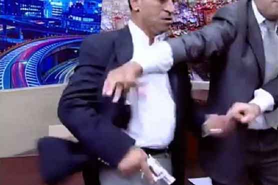 Politician pulls gun on man during TV show
