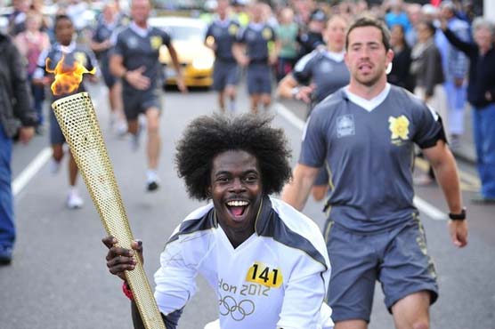 Sun comes out as Olympic torch tours London