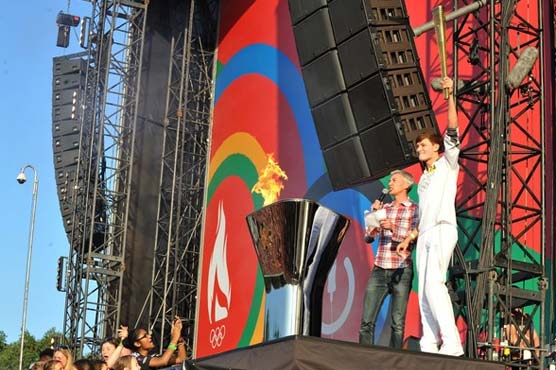 Victory lap: Olympic torch cheered through London