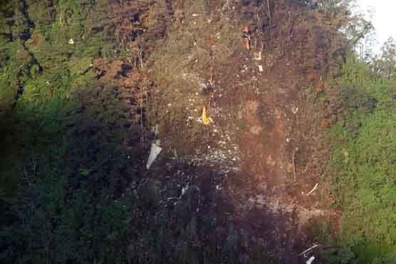 Indonesian climbers near Russian plane wreckage