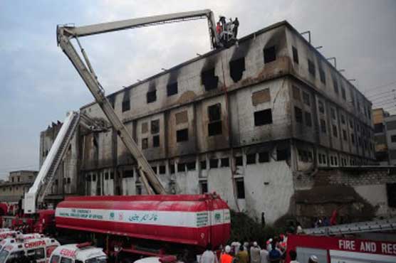 Families await bodies after Karachi factory fire