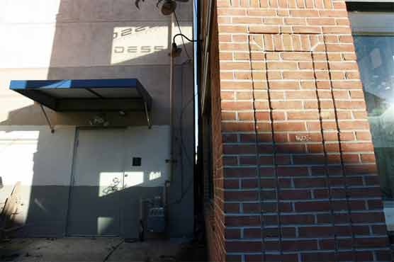 Woman stuck in air between two buildings