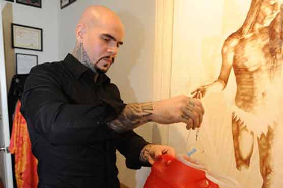 Using his own blood, artist paints 'Resurrection' exhibit