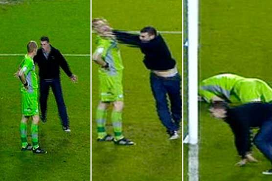 Goalkeeper attacked by fan as derby turns ugly