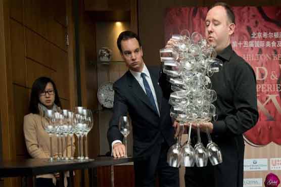 Brit handles 51 wine glasses in one hand  