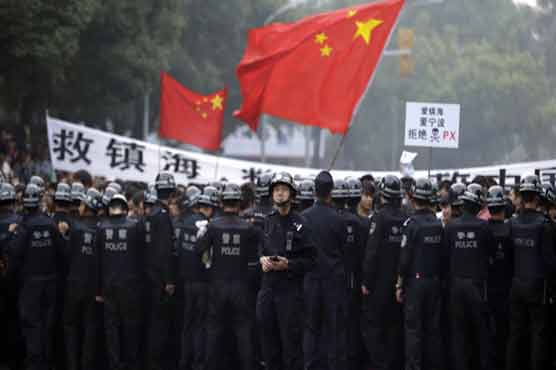 China halts factory expansion after protests 