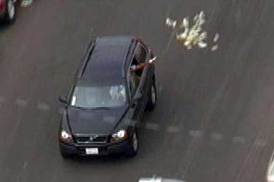 Throwing bundles of cash from car