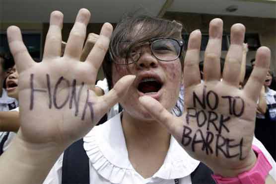 Woman tied to Philippine graft scandal surrenders