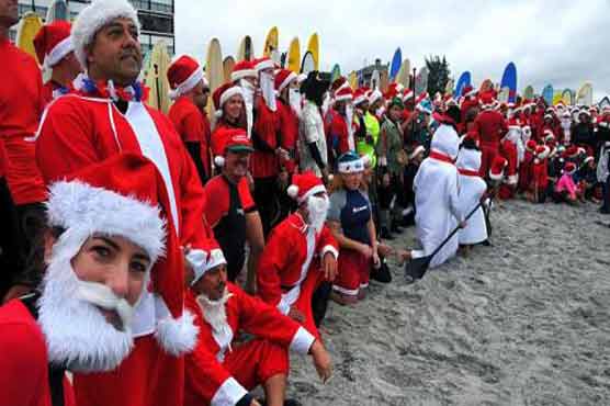 Surfers dressed as Santa Claus gather in Florida