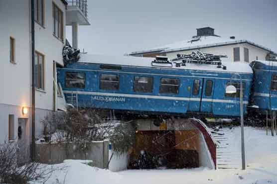 Stolen train crashes into apartments 