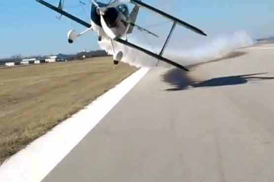 Biplane narrowly misses camerawoman