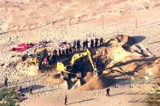 Boy pulled from dune responsive, says doctors