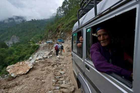 Indian journalist reports floods perched on victim's shoulders