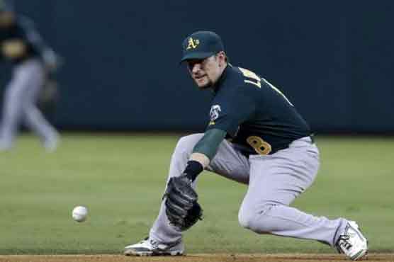A's beat Reds to go top of AL West 