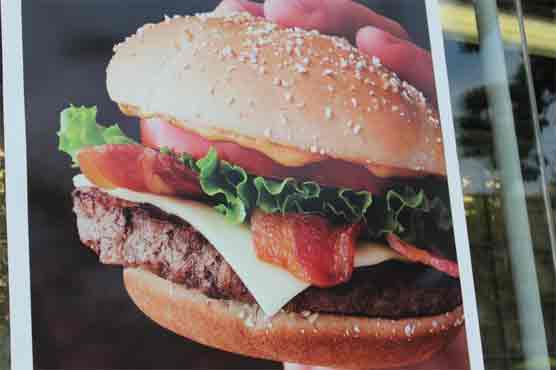 Drunk woman tries to wear cheeseburger as a shoe