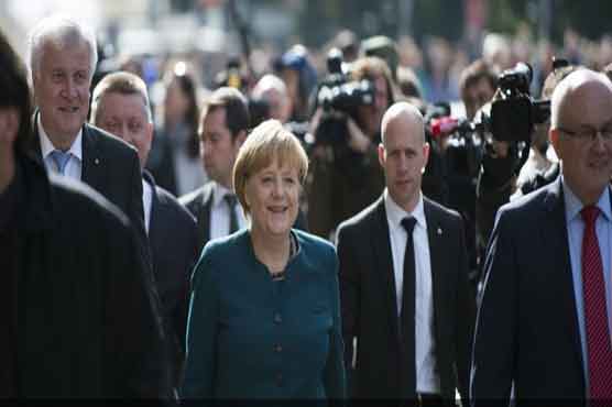 Merkel starts exploratory talks with defeated rivals