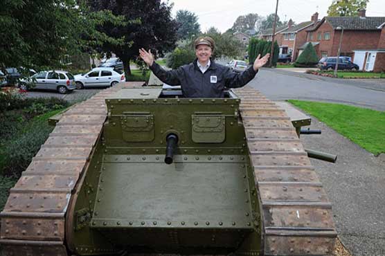 Military enthusiast parts replica WW-I tank outside his home