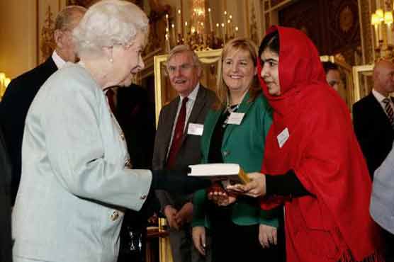 Malala presents her book to Queen Elizabeth