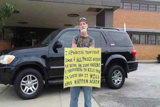  Ohio Man who threatened police holds 'Idiot' sign