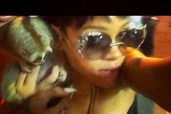 Rihanna poses with protected primate in Thailand 