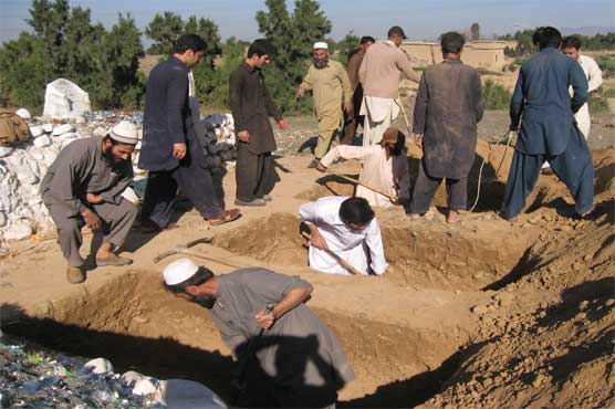Burying the dead after Pakistan's school massacre