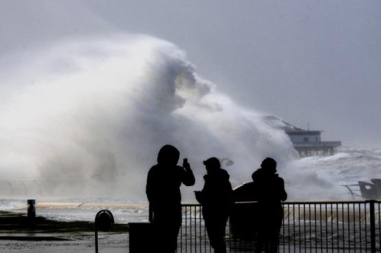 Storms, high winds batter flooded parts of Britain