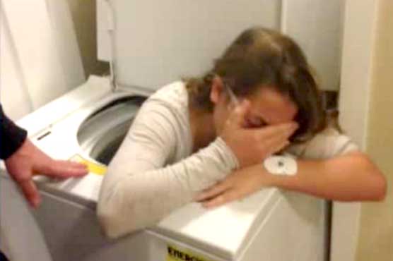 Girl stuck in washing machine