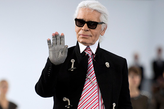 Chanel models in sorbet pink skip down stairs at Paris fashion show