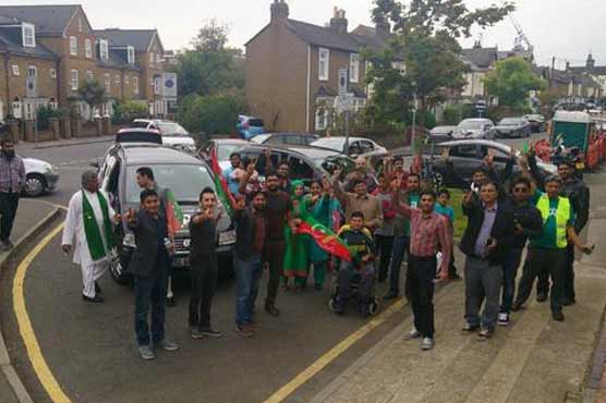 Protesters chant slogans outside Nawaz's London residency
