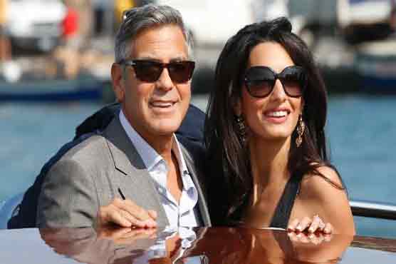 Newlywed Clooneys show off rings after 'perfect' wedding