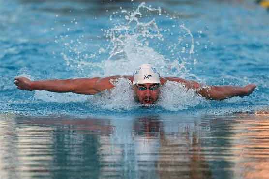 Swimming: Phelps glad to be back after 100m butterfly win