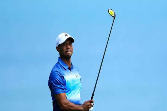 Golf: Balky putter leaves Woods well back