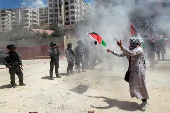 Israeli troops fire tear gas at separation barrier demo
