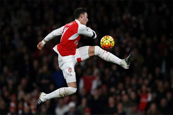 Football: Inspired Ozil fires Arsenal to top spot