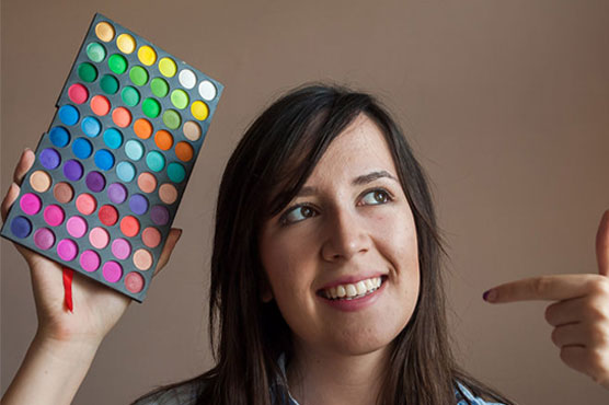 Makeup artists work in shadows to transform celebrities