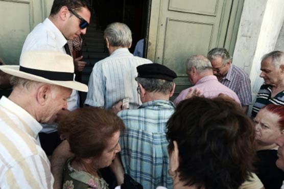 Banks reopen, taxes rise as Greece pays billions to creditors