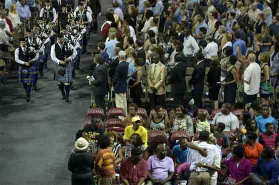 Thousands attend vigil as US church suspect held on murders 