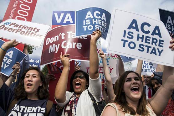 U.S. top court backs Obamacare, president says it's here to stay