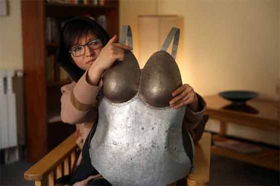 Afghan artist dons armor to protest street harassment