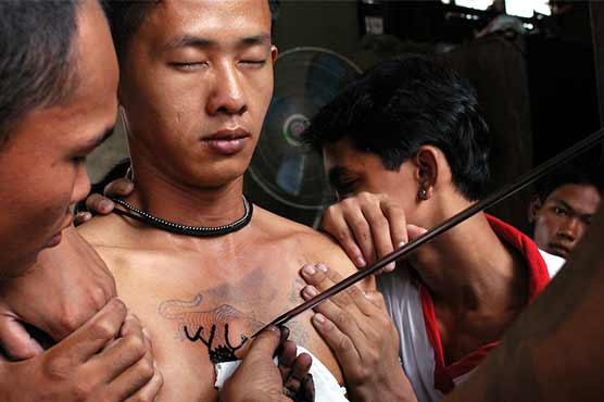 'Animal' trances and tattoos at Thai Buddhist festival