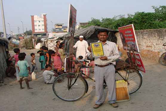 Indian teacher gets on his bike to help slum children