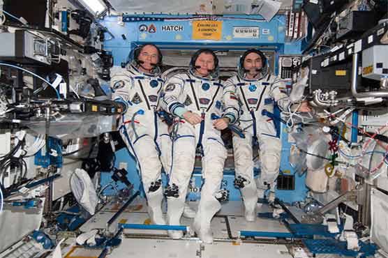Astronauts board Soyuz to return to Earth